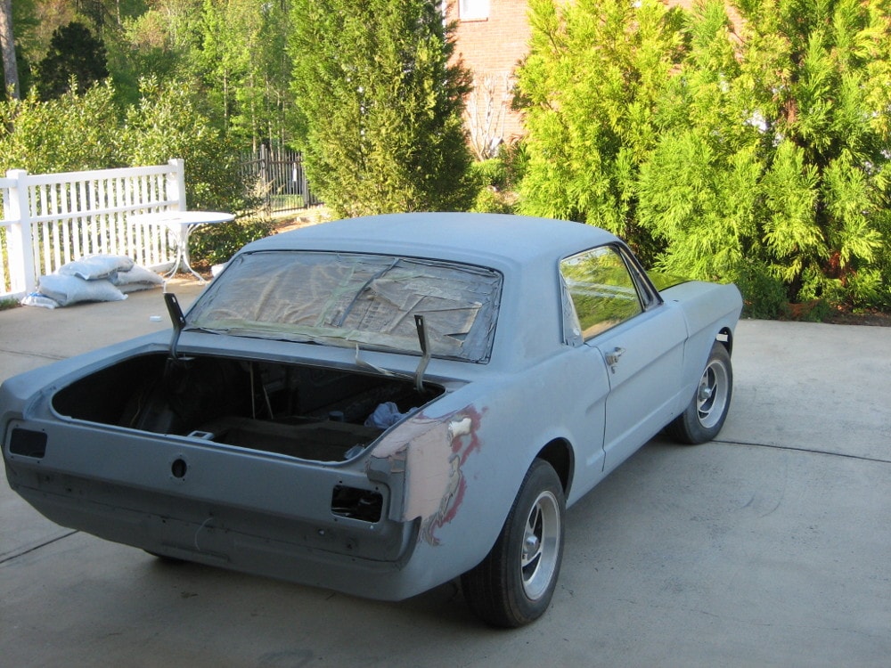 1965 Mustang 289 V8 Ford Coupe. Body restoration of 1965 Mustang in primer gray. Ford Mustang in gray primer. Classic car, 1965 Ford Mustang body work in primer.