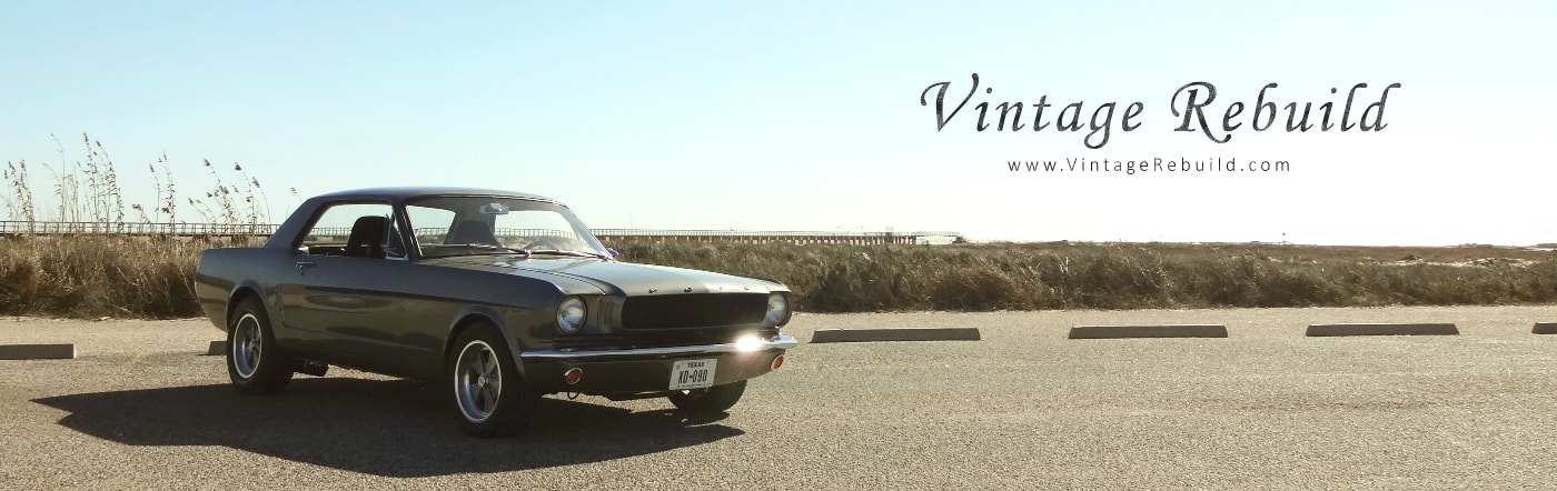 Gray 1965 Ford Mustang Coupe with pier and beach background, American summer