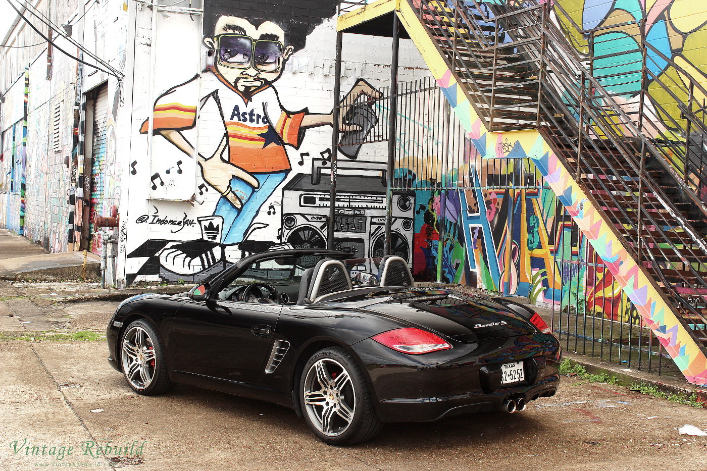 Black Porsche Boxster S 987.2 at Graffiti Wall Houston with Astros Man. Porsche Boxster S, a German luxury car. This black porsche Boxster S is a 987.2 Boxster with convertible top.