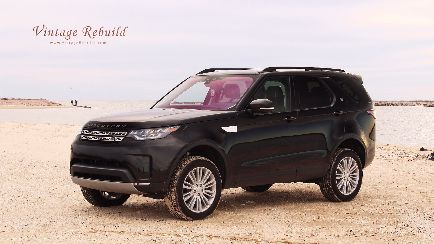 Black 2017 Land Rover Discovery HSE Luxury SUV offroad driving on beach sand at sunset, Jetty Park, Matagorda, Texas.